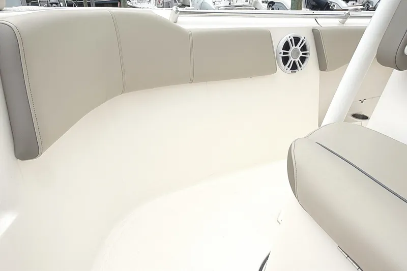 Slide: The Image of 2024 Key West 263 FS boat interior with beige seating and speaker detail. - 27