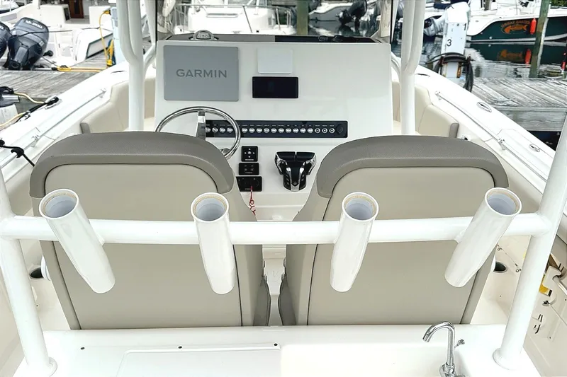 Slide: The Image of 2024 Key West 263 FS boat cockpit with Garmin navigation and dual seats at the dock. - 11
