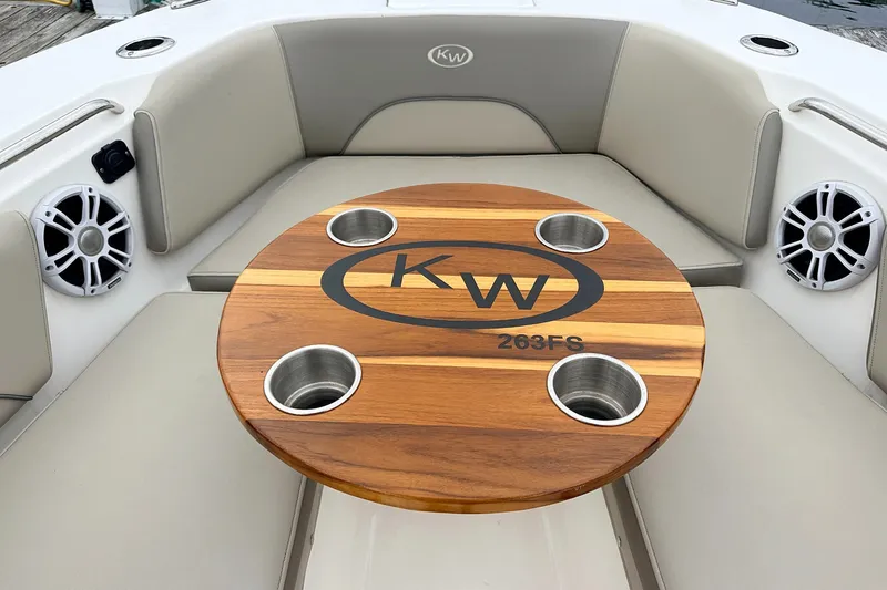 Slide: The Image of 2024 Key West 263 FS boat interior with wooden table and cup holders. - 10