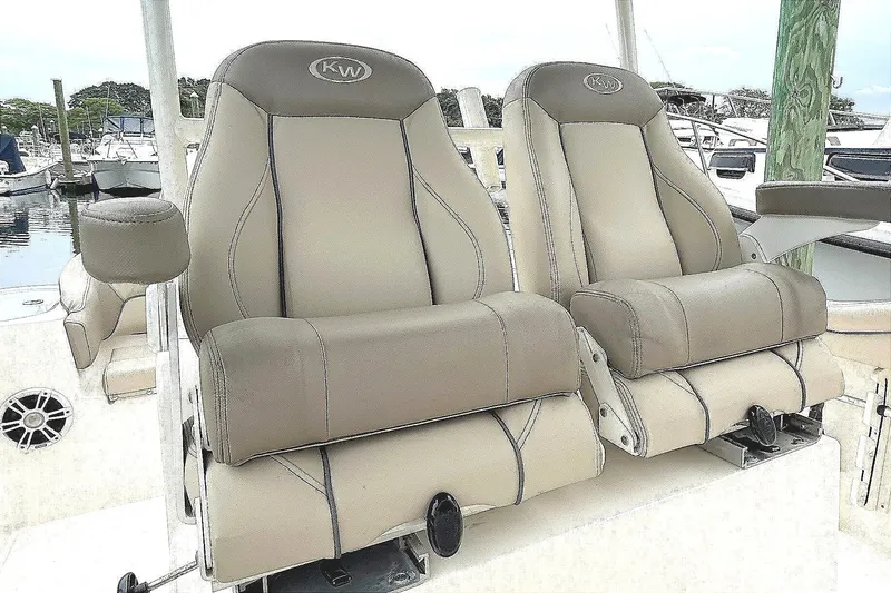 Slide: The Image of 2024 Key West 263 FS boat seats, beige leather, docked at marina. - 7
