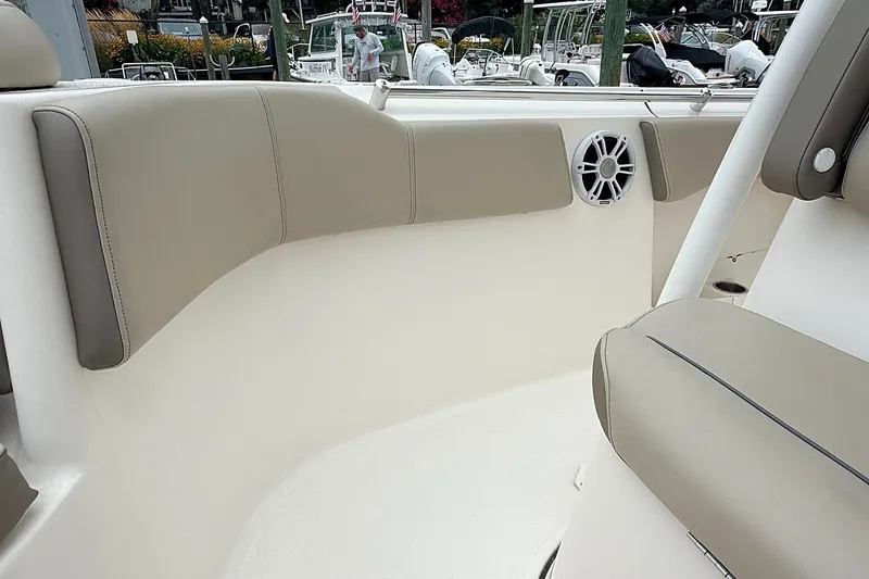 Slide: The Image of 2024 Key West 263 FS boat interior with beige seating and speaker. - 30