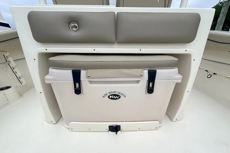 Slide: The Image of 2024 Key West 263 FS boat cooler with cushioned seat and storage compartment. - 19