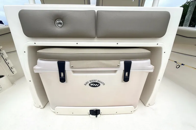 Slide: The Image of 2024 Key West 263 FS boat cooler with cushioned seat and storage compartment. - 16