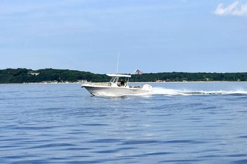 Slide: The Image of 2024 Key West 263 FS boat cruising on calm waters under a clear sky. - 5