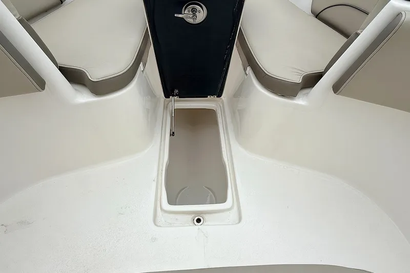 Slide: The Image of 2024 Key West 263 FS boat interior with open storage compartment and cushioned seating. - 35