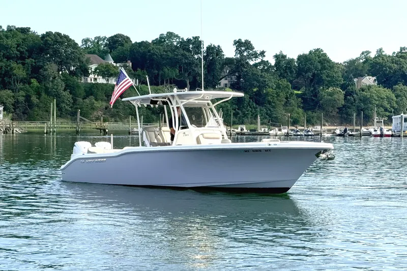 Slide: The Image of 2024 Key West 263 FS boat on calm water with American flag. - 3