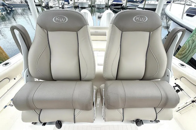 Slide: The Image of 2024 Key West 263 FS boat seats, gray upholstery, docked at marina. - 8