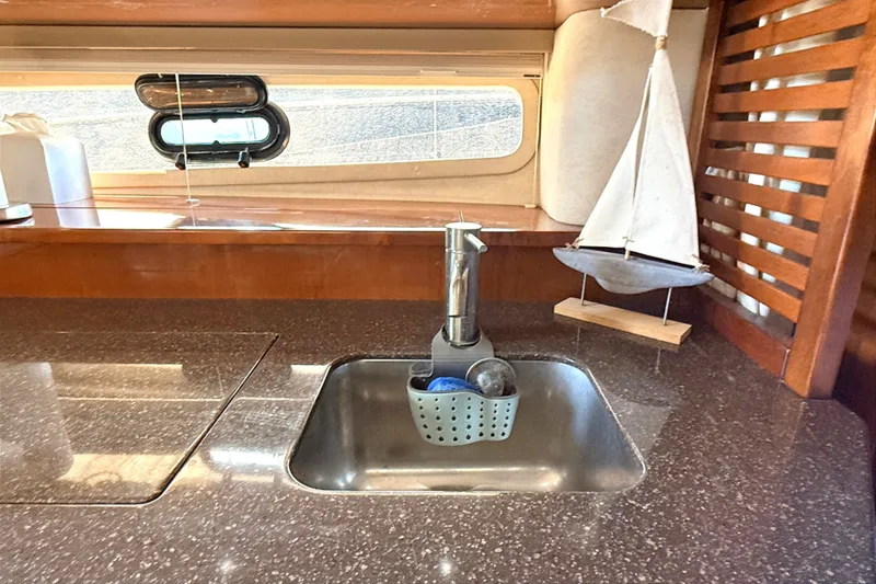 Slide: The Image of Interior of 2013 Sea Ray Sundancer 370 yacht kitchen with sink and decorative sailboat. - 32