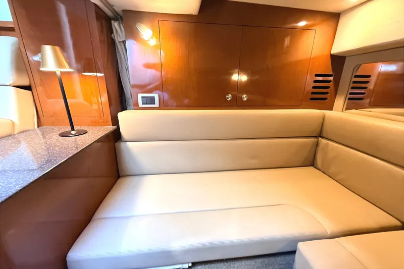 Slide: The Image of Luxurious interior of 2013 Sea Ray Sundancer 370 yacht with beige seating and wooden cabinetry. - 23