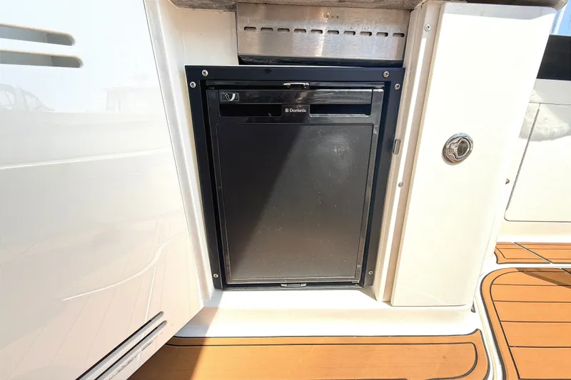 Slide: The Image of Built-in refrigerator on 2013 Sea Ray Sundancer 370 yacht, featuring teak flooring. - 10