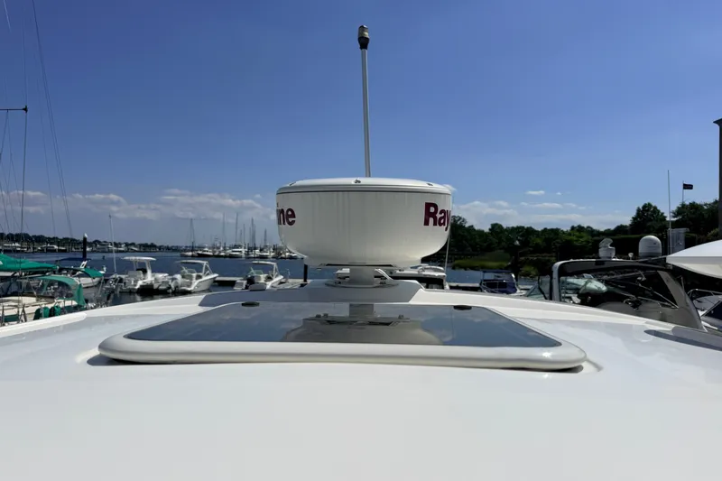 Slide: The Image of 2013 Sea Ray Sundancer 370 with radar, docked at a marina under clear skies. - 41