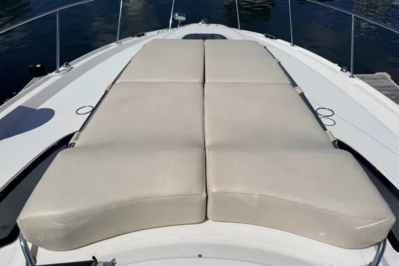 Slide: The Image of Sunbathing deck on 2013 Sea Ray Sundancer 370 yacht, featuring comfortable beige cushions. - 5