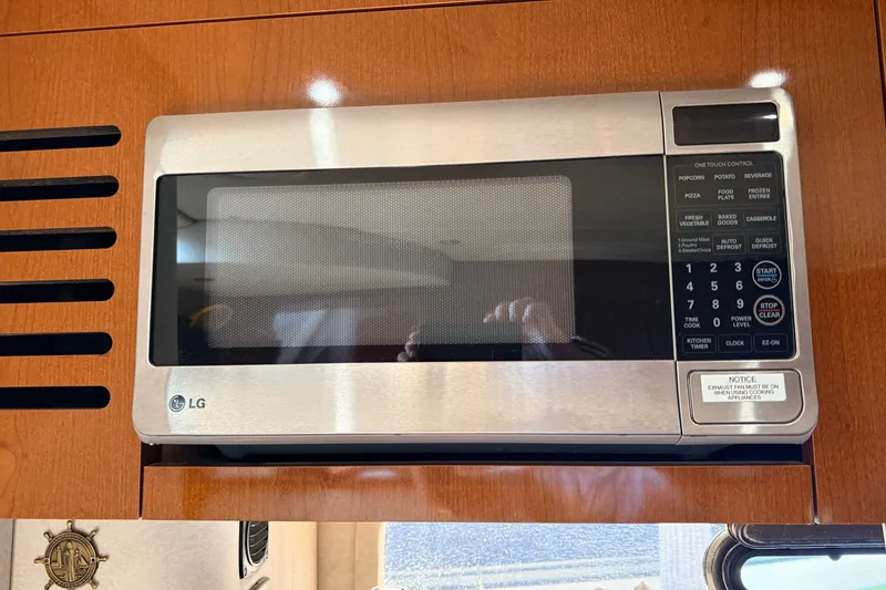 Slide: The Image of LG microwave in 2013 Sea Ray Sundancer 370 yacht kitchen, mounted in wooden cabinetry. - 34