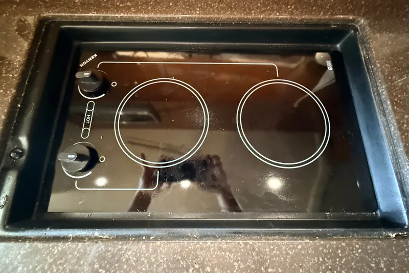 Slide: The Image of Built-in stovetop on 2013 Sea Ray Sundancer 370 yacht, featuring dual burners and control knobs. - 35