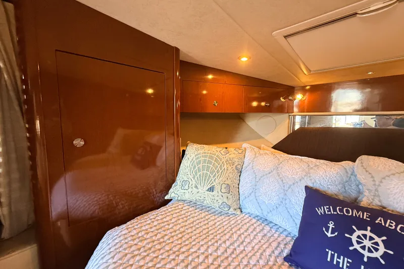 Slide: The Image of Cozy cabin interior of 2013 Sea Ray Sundancer 370 with nautical-themed pillows. - 31
