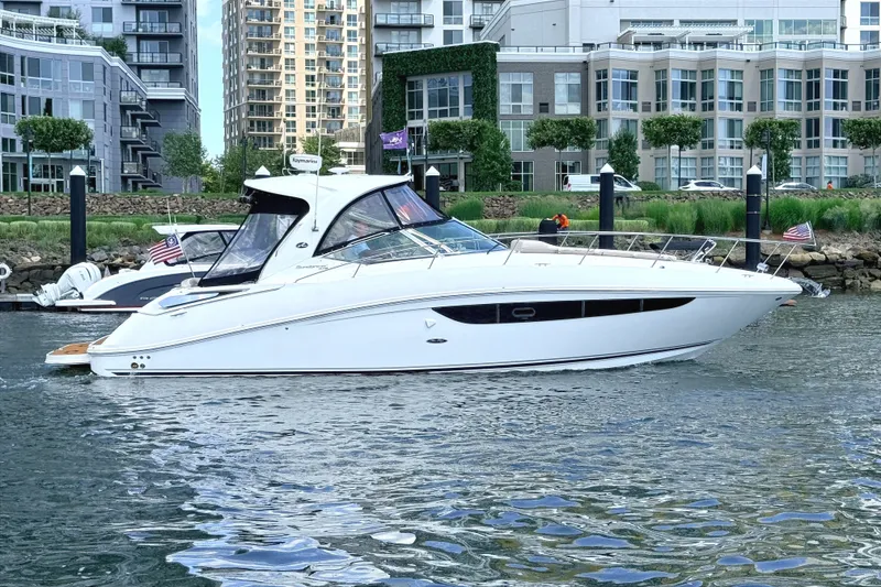 Slide: The Image of 2013 Sea Ray Sundancer 370 yacht docked in urban marina setting. - 3