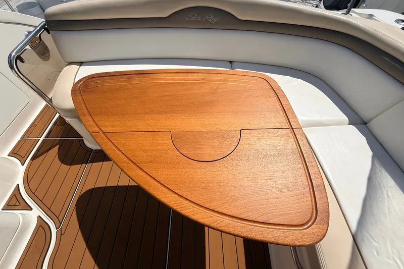 Slide: The Image of Luxurious 2013 Sea Ray Sundancer 370 boat interior with elegant wooden table and cushioned seating. - 7