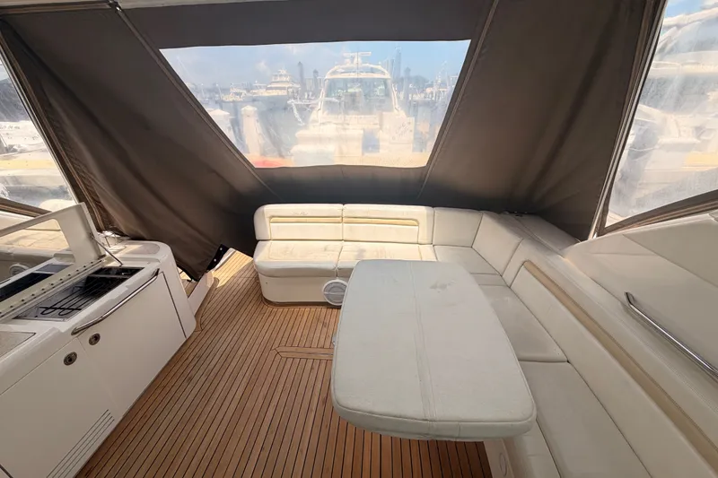 Slide: The Image of 2010 Sea Ray Sundancer 540 interior with seating and table, featuring teak flooring. - 23