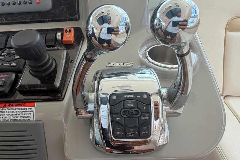 Slide: The Image of Control panel of a 2010 Sea Ray Sundancer 540 yacht with joystick and throttle levers. - 20