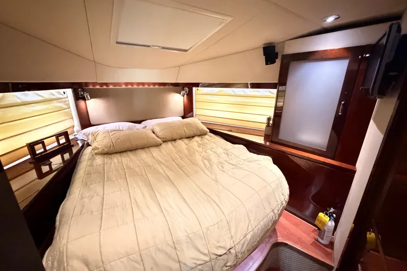 Slide: The Image of Luxurious bedroom interior of 2010 Sea Ray Sundancer 540 yacht with cozy bedding. - 14