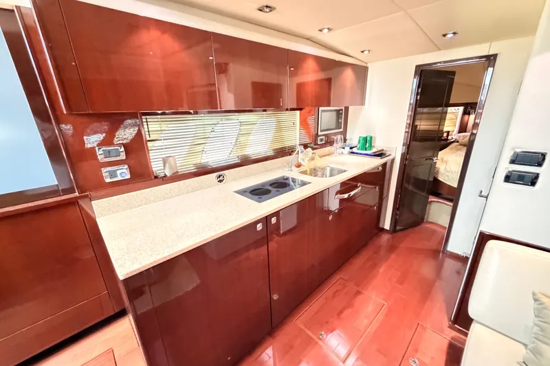 Slide: The Image of Luxurious 2010 Sea Ray Sundancer 540 yacht kitchen with sleek cabinetry and modern appliances. - 15