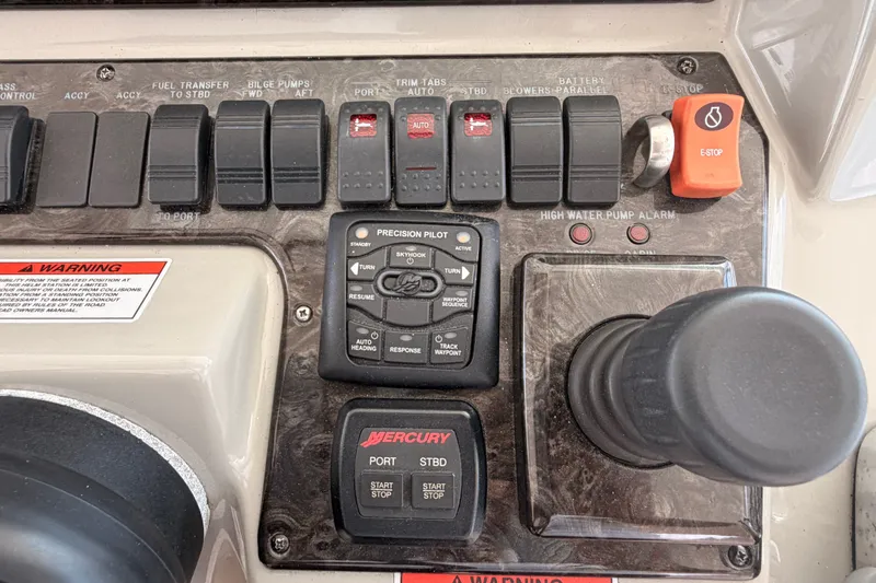 Slide: The Image of Control panel of a 2010 Sea Ray Sundancer 540 yacht with various switches and joystick. - 19
