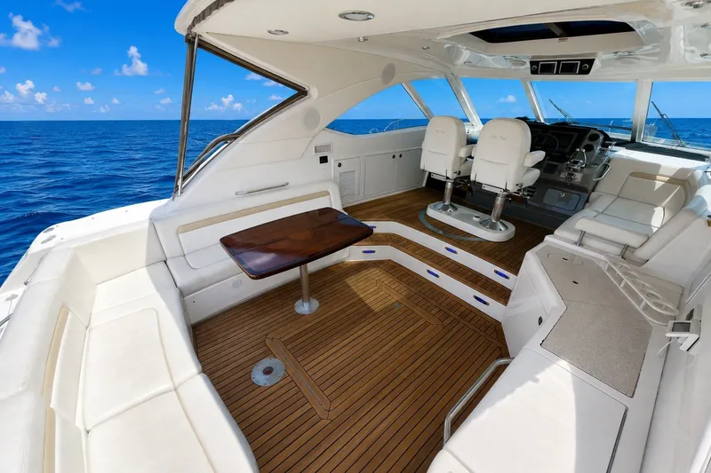 Slide: The Image of Luxurious 2010 Sea Ray Sundancer 540 yacht interior with ocean view, featuring elegant seating and helm. - 3