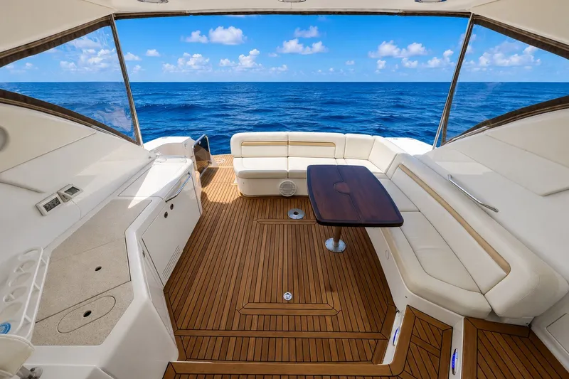 Slide: The Image of Luxurious 2010 Sea Ray Sundancer 540 yacht interior with ocean view, featuring elegant seating and wooden flooring. - 2