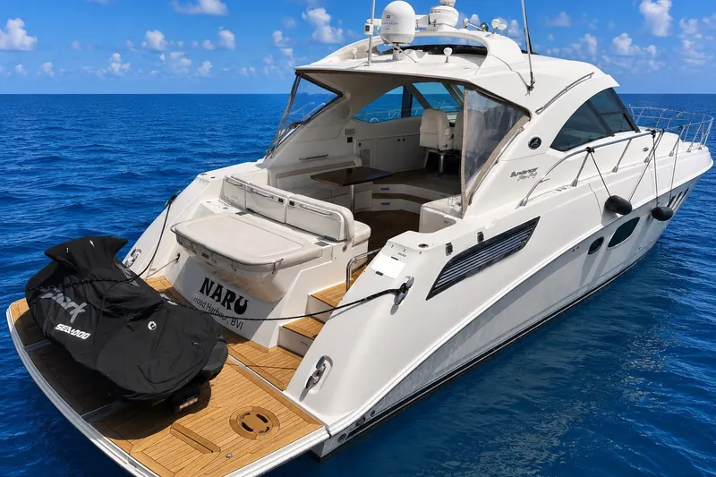 Slide: The Image of 2010 Sea Ray Sundancer 540 yacht on open ocean, featuring spacious deck and sleek design. - 4
