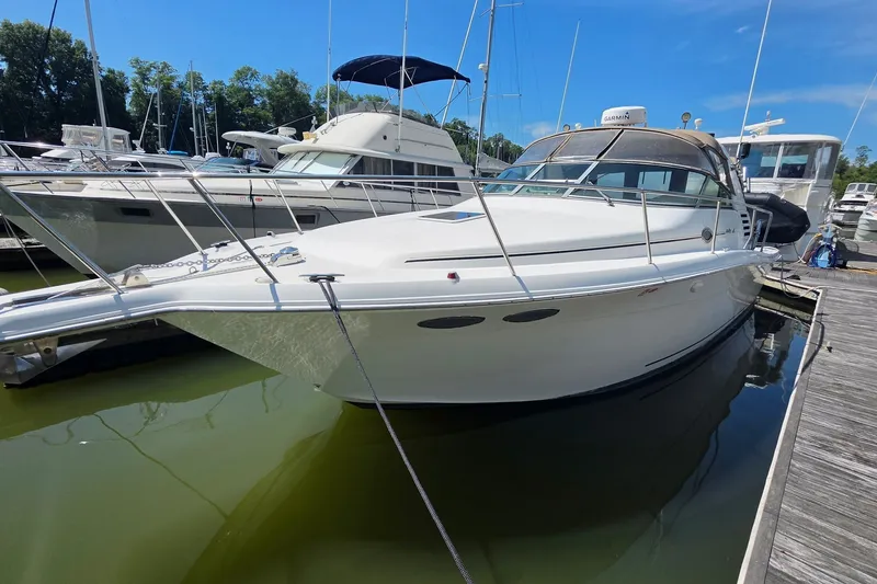 The Image of 1998 Sea Ray 340 Amberjack docked at marina under clear blue sky. - 0