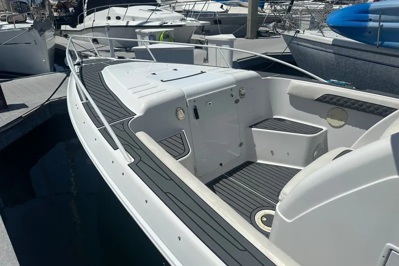 Slide: The Image of 2007 Donzi 35 ZF Cuddy boat docked, featuring sleek design and spacious deck. - 9