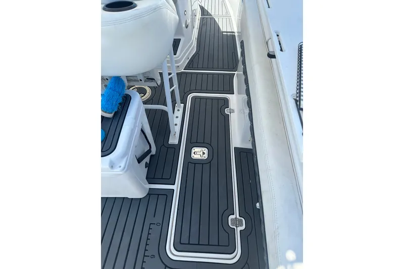 Slide: The Image of 2007 Donzi 35 ZF Cuddy boat deck with sleek black and white flooring. - 18