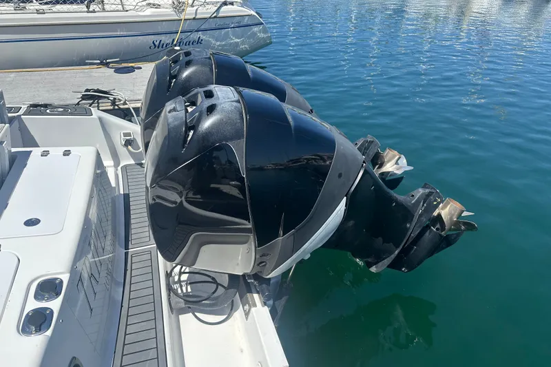 Slide: The Image of 2007 Donzi 35 ZF Cuddy with dual outboard motors docked on water. - 7