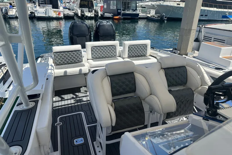 Slide: The Image of 2007 Donzi 35 ZF Cuddy boat interior with luxurious seating at marina. - 8