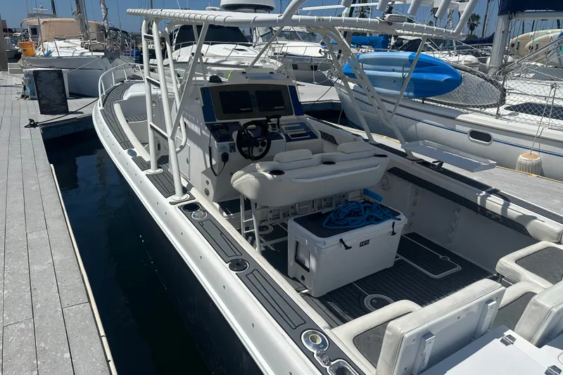Slide: The Image of 2007 Donzi 35 ZF Cuddy boat docked, featuring a spacious cockpit and modern controls. - 5