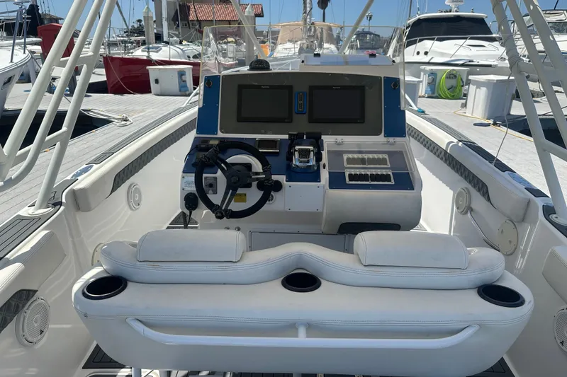 Slide: The Image of 2007 Donzi 35 ZF Cuddy boat cockpit with steering wheel and control panel at marina. - 6