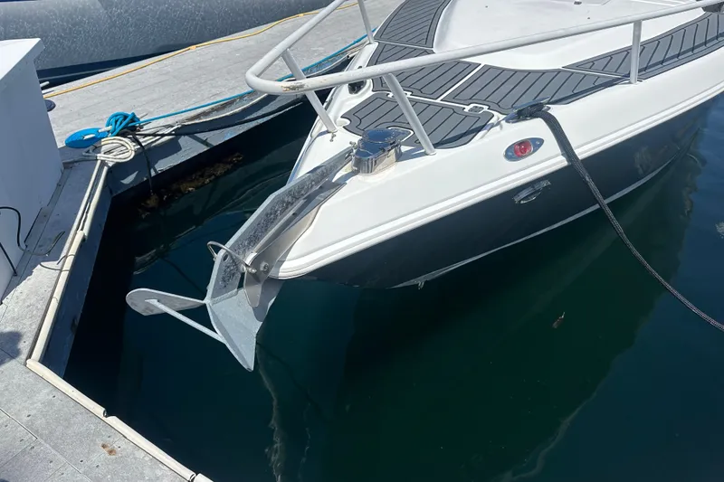 Slide: The Image of 2007 Donzi 35 ZF Cuddy boat docked, featuring sleek design and anchor. - 20