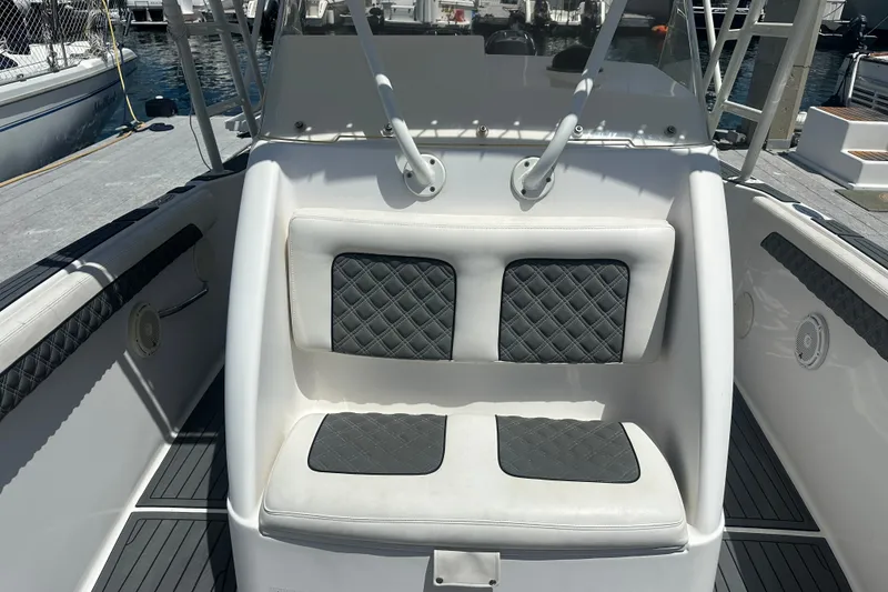 Slide: The Image of 2007 Donzi 35 ZF Cuddy boat interior with cushioned seating and marine equipment. - 14