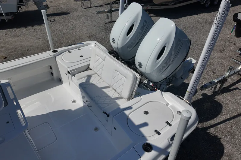 Slide: The Image of 2027 Blazer Bay Makaira 2800 boat with dual Suzuki engines and white seating. - 14