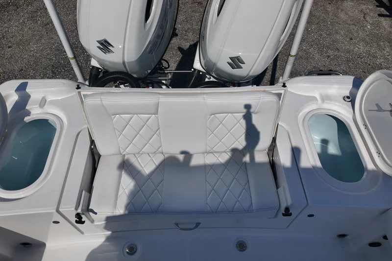 Slide: The Image of 2027 Blazer Bay Makaira 2800 boat interior with dual engines and cushioned seating. - 15