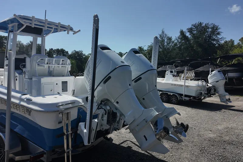 Slide: The Image of 2027 Blazer Bay Makaira 2800 boat with dual outboard engines in a sunny outdoor setting. - 17