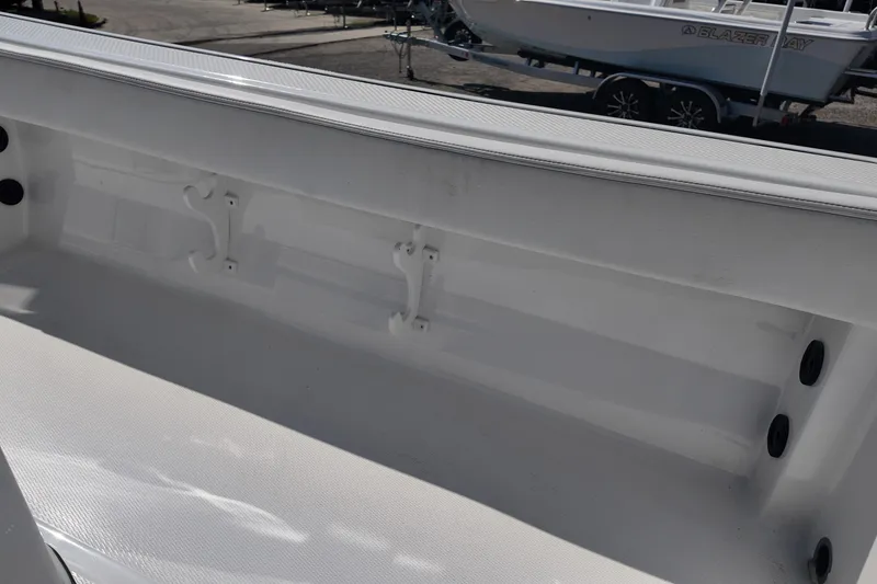 Slide: The Image of 2027 Blazer Bay Makaira 2800 boat interior detail with rod holders and storage space. - 20