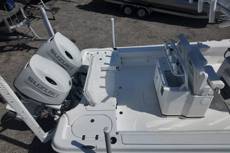 Slide: The Image of 2027 Blazer Bay Makaira 2800 boat with dual Suzuki outboard engines, featuring a spacious deck. - 22