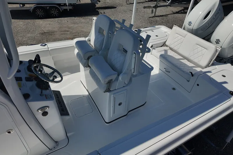 Slide: The Image of 2027 Blazer Bay Makaira 2800 boat interior with white seating and steering console. - 13