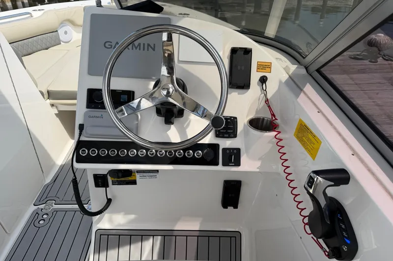 Slide: The Image of 2025 Key West 239 DFS boat dashboard with Garmin navigation and modern controls. - 18