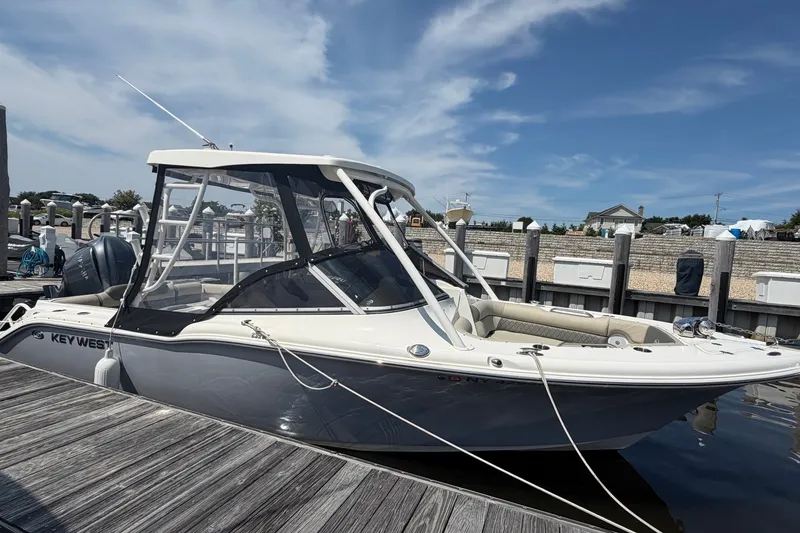 The Image of 2025 Key West 239 DFS boat docked at marina under clear blue sky. - 0