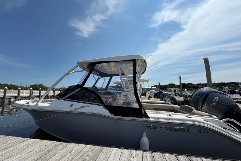 Slide: The Image of 2025 Key West 239 DFS boat docked under a clear blue sky. - 29
