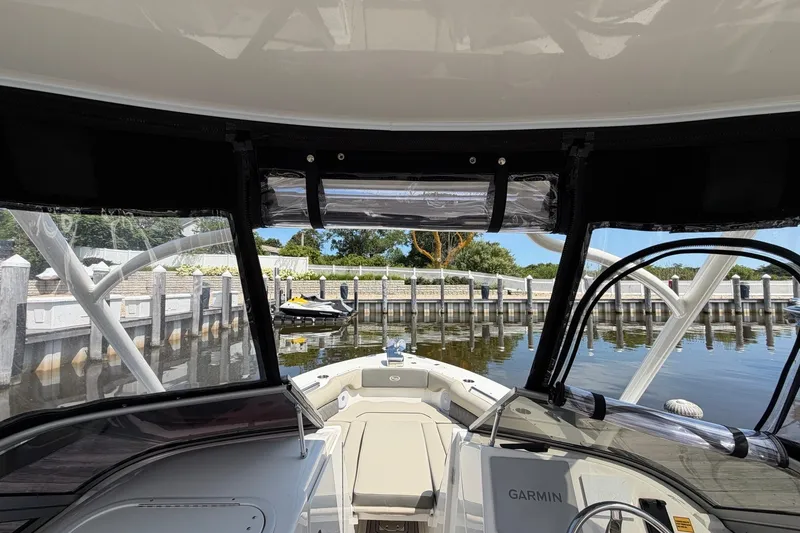 Slide: The Image of 2025 Key West 239 DFS boat interior view at a dock with clear skies. - 21