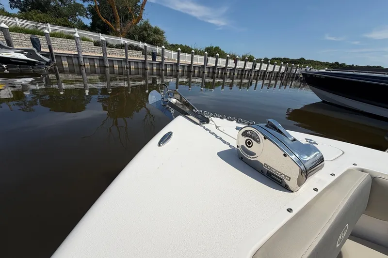 Slide: The Image of 2025 Key West 239 DFS boat anchored at a serene dockside under a clear blue sky. - 26