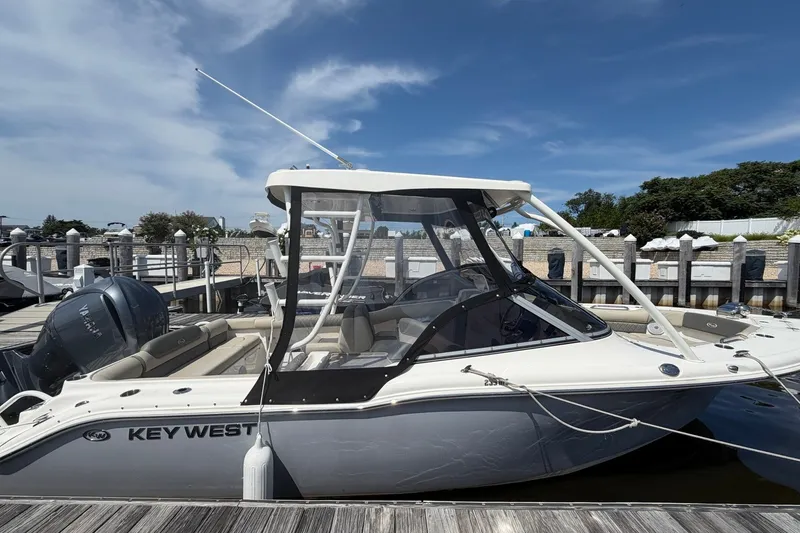 Slide: The Image of 2025 Key West 239 DFS boat docked at marina under clear blue sky. - 28